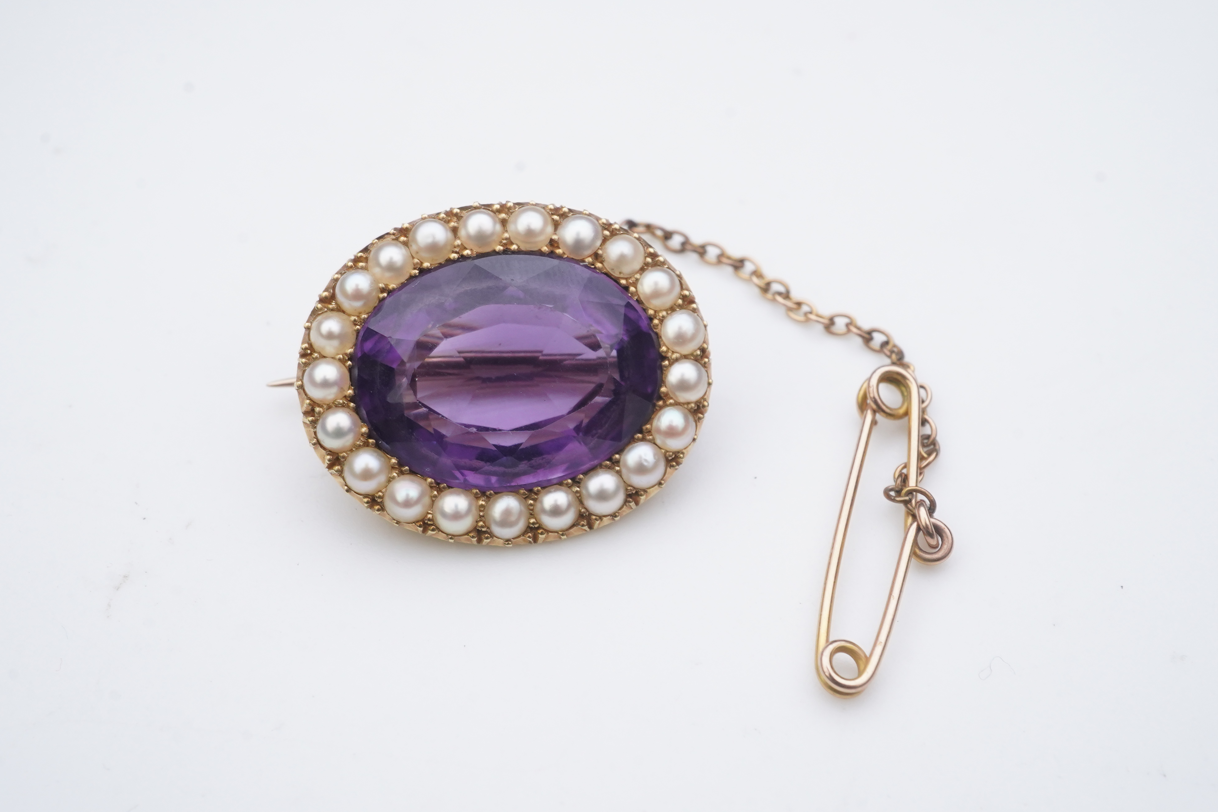 An amethyst and split pearl brooch, circa 1900